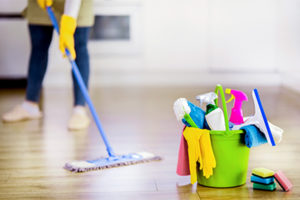 mopping floor near cleaning supplies