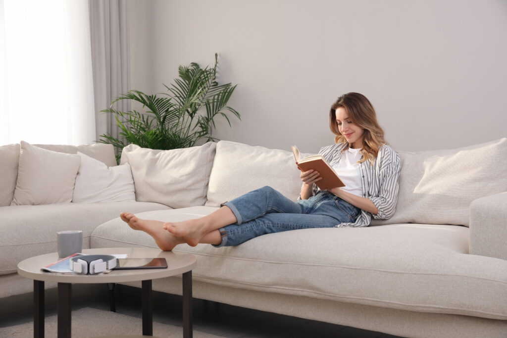 Women on couch, enjoying the benefits of decluttering